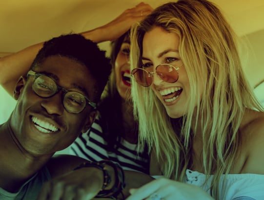 three people wearing sunglasses smiling