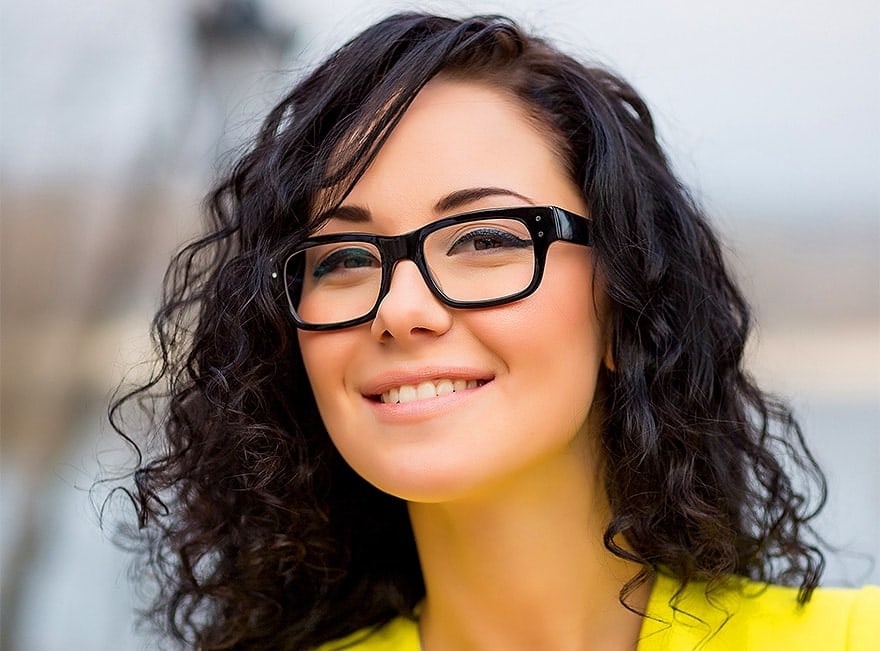 woman with glasses smiling